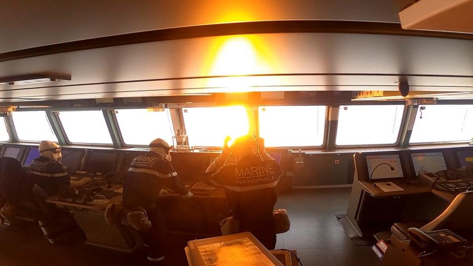 French sailors watch a missile launch.