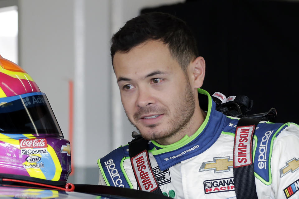 FILE - In this Feb, 8, 2020, file photo, Kyle Larson climbs into his car as he gets ready for a NASCAR auto race practice at Daytona International Speedway, in Daytona Beach, Fla. Despite being suspended for six months for the use of a racial slur, Kyle Larson remains a popular figure in dirt track racing. (AP Photo/Terry Renna, File)