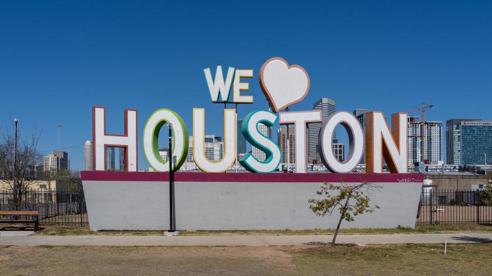 The sign ‘We Love Houston’ with Downtown Houston in background is shown in Houston, Texas, USA