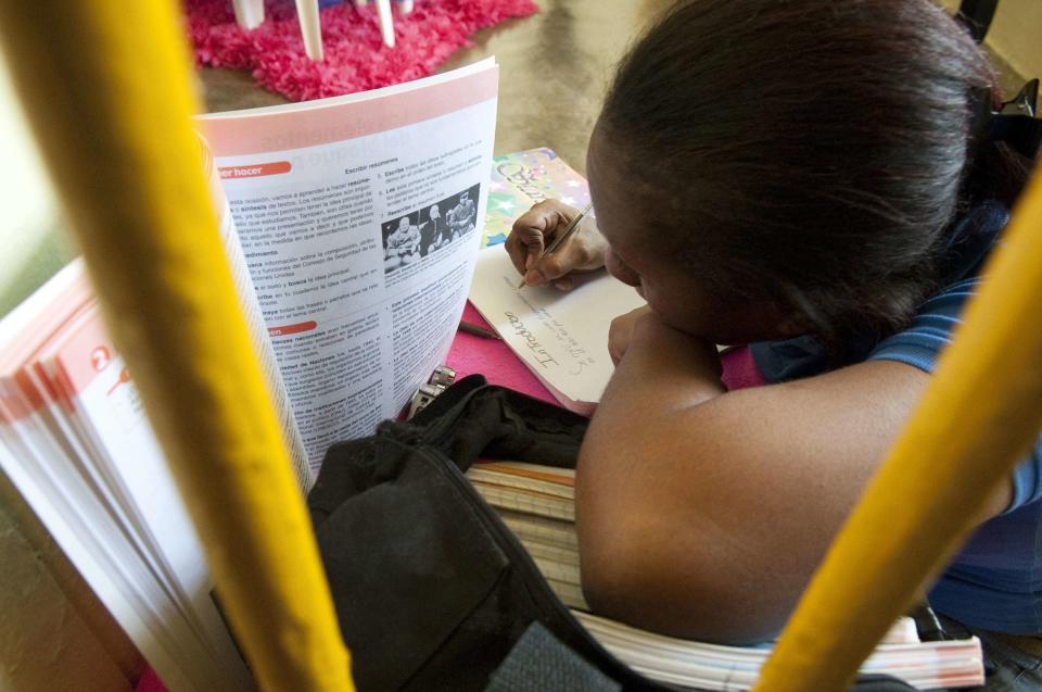 A prisoner studies in her cell inside the renovated wing of the Najayo Women's prison in San Cristobal