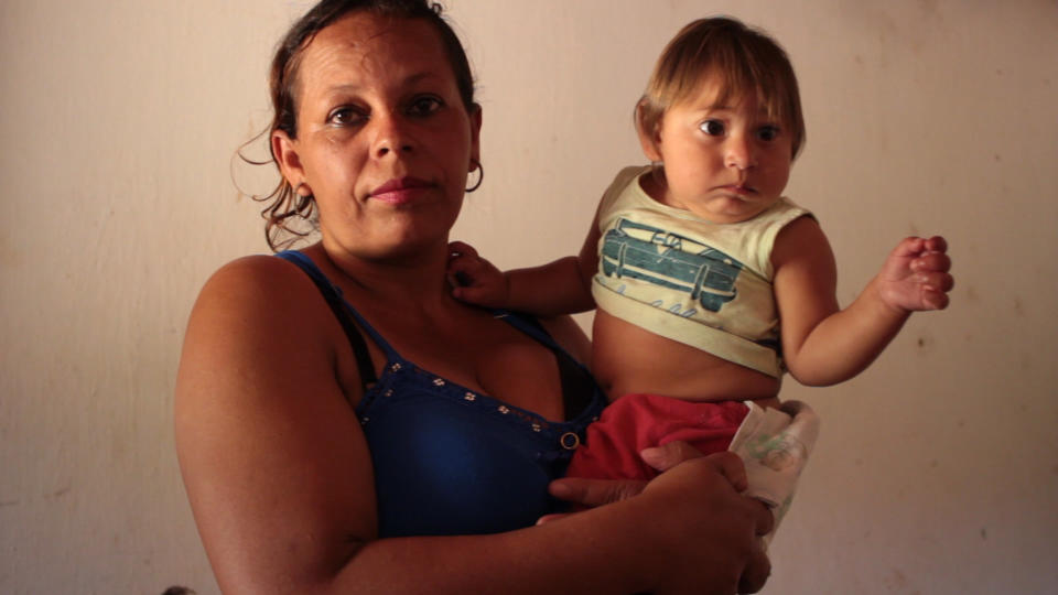 Ros&acirc;ngela Ferreira de Barros holds her son Miguel, who was born with congenital Zika syndrome.&nbsp; (Photo: Jul Sousa for HuffPost)