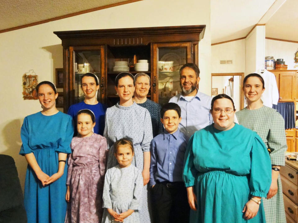 This photo taken around Christmas 2019 and provided by Robert Krause shows members of the Krause family at their home in Grandview, Texas. Sasha Krause, shown wearing a light blue, patterned dress and head scarf, was killed in early 2019. Air Force Airman Mark Gooch was found guilty of first-degree murder of Sasha and will be sentenced Jan. 19, 2022. (Family Photo/Robert Krause via AP)