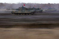 Japanese Ground-Self Defense Force (JGDDF) Type 90 tanks drive toward a target during the annual drill with live ammunitions exercise at Minami Eniwa Camp Monday, Dec. 6, 2021, in Eniwa, northern Japan of Hokkaido. Dozens of tanks are rolling over the next two weeks on Hokkaido, a main military stronghold for a country with perhaps the world's most little known yet powerful army. (AP Photo/Eugene Hoshiko)