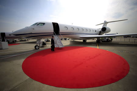 FILE PHOTO: A man walks on a red carpet in front of the Gulfstream G650 ER aircraft at Asian Business Aviation Conference and Exhibition (ABACE) at Hongqiao International Airport in Shanghai, China, April 11, 2016. REUTERS/ Aly Song/ File Photo