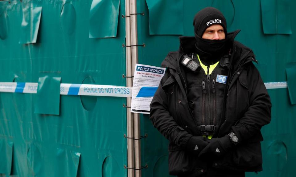 police officer stands next to screening