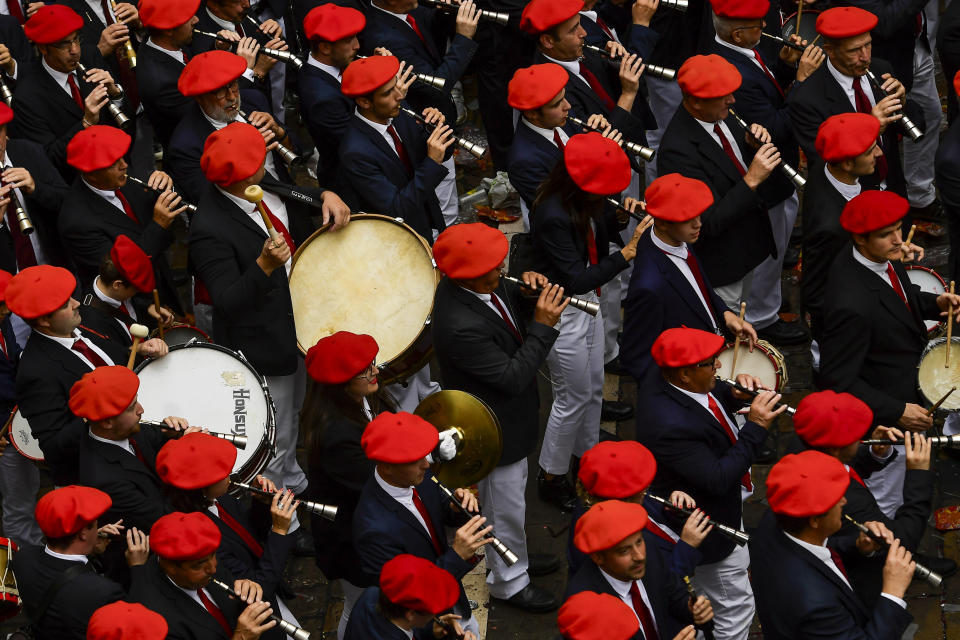 A music band plays in the town hall square after the 'Chupinazo' rocket, to mark the official opening of the 2023 San Fermín fiestas in Pamplona, Spain, Thursday, July 6, 2023. (AP Photo/Alvaro Barrientos)