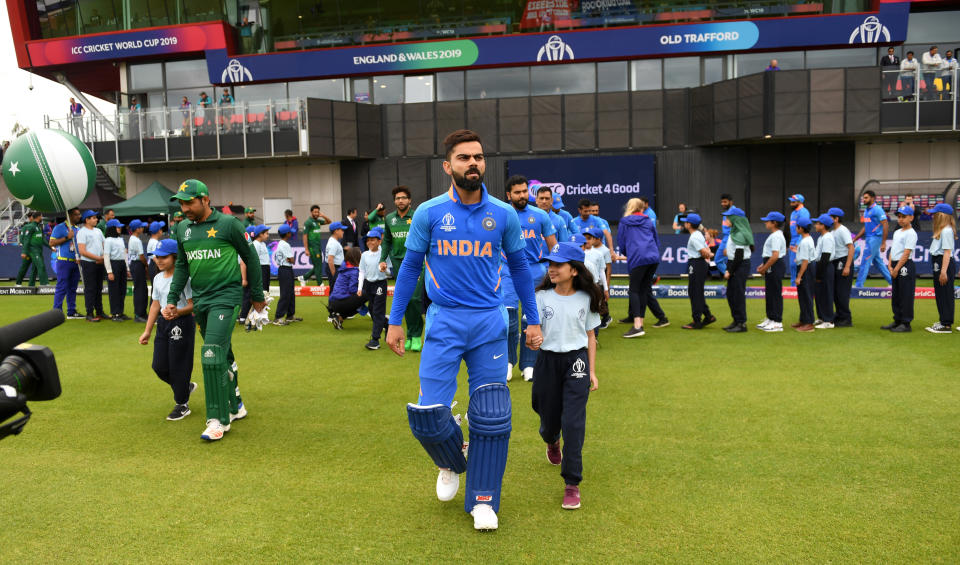 Captain's Virat Kohli and Sarfaraz Ahmed lead out their teams (Photo by Gareth Copley-IDI/IDI via Getty Images)