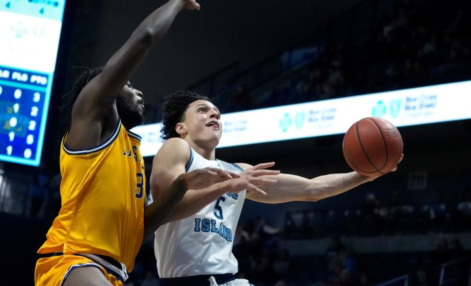 URI guard Always Wright hooks a shot over La Salle's Anwar Gill.