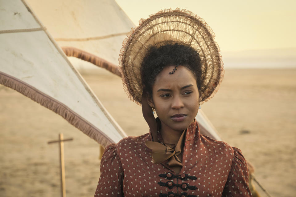 Georgiana (Crystal Clarke) stands on the beach looking perturbed