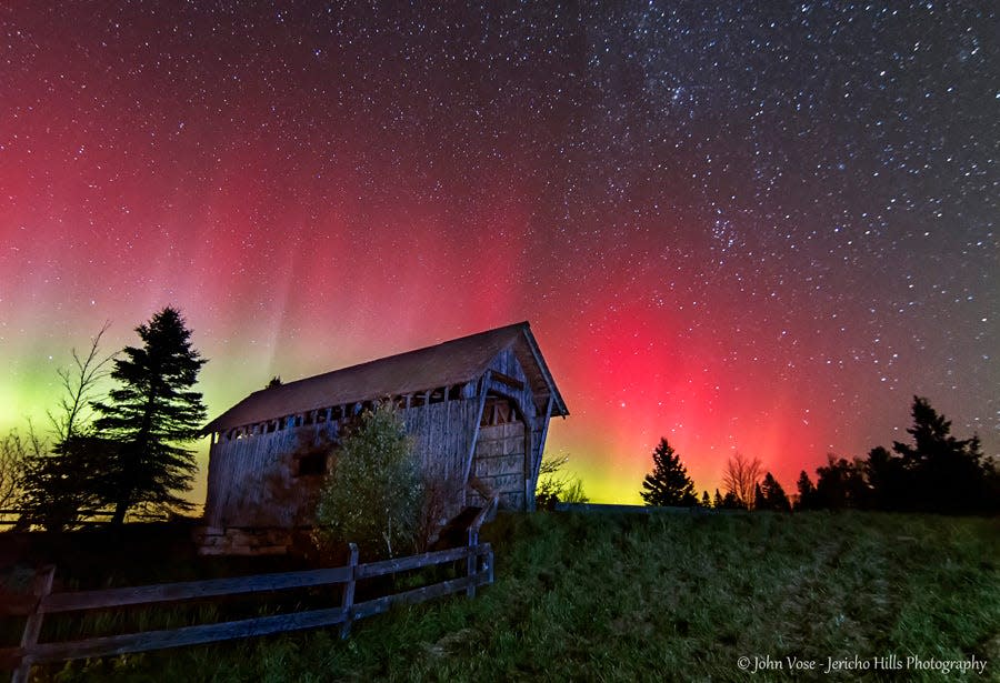 The aurora borealis, or northern lights, paints the sky over Foster’s Bridge in Cabot on the night of Oct. 8, 2013.