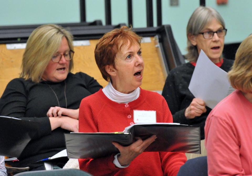 Snug Harbor Community Chorus members, from left, Julie Oliver, of Plymouth; Jody Mathewson, of Plymouth; and Paula Fisher, of Kingston, rehearse for their upcoming 25th anniversary concert at the Duxbury Performing Arts Center. Monday, May 3, 2022.