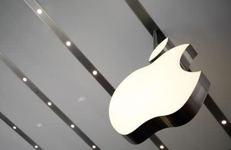 The Apple logo is pictured inside the newly opened Omotesando Apple store at a shopping district in Tokyo June 26, 2014. Picture taken June 26. REUTERS/Yuya Shino