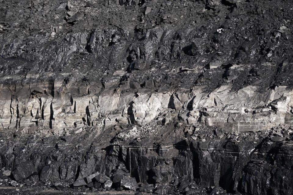 Coal sits at the Trapper Mine on Thursday, Nov. 18, 2021, in Craig, Colo. The town in northwest Colorado is losing its coal plant, along with the mine that feeds it and residents fear it is the beginning of the end for their community. (AP Photo/Rick Bowmer)