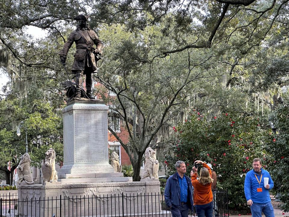 A person takes a photo of a statue of James Edward Oglethorpe stands in Chippewa Square in Savannah, Ga. on Feb. 9, 2024. Oglethorpe founded Georgia as the last of Britain's 13 American colonies in February 1733. Slavery was banned in the early years of Oglethorpe's Georgia, though the prohibition ultimately failed. A new book by Michael Thurmond, a Black veteran of Georgia politics and a history aficionado, argues that Oglethorpe deserves credit as a forefather of early abolitionists. (AP Photo/Russ Bynum)