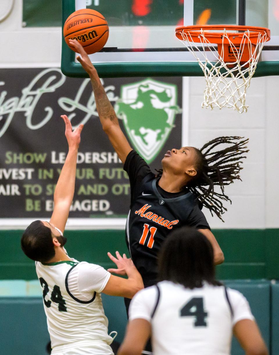 Manual's Dietrich Richardson (11) tries to block a shot by Richwoods' Sabri Qattum in the first half Tuesday, Jan. 10, 2023 at Richwoods High School. The Knights defeated the Rams 70-54.