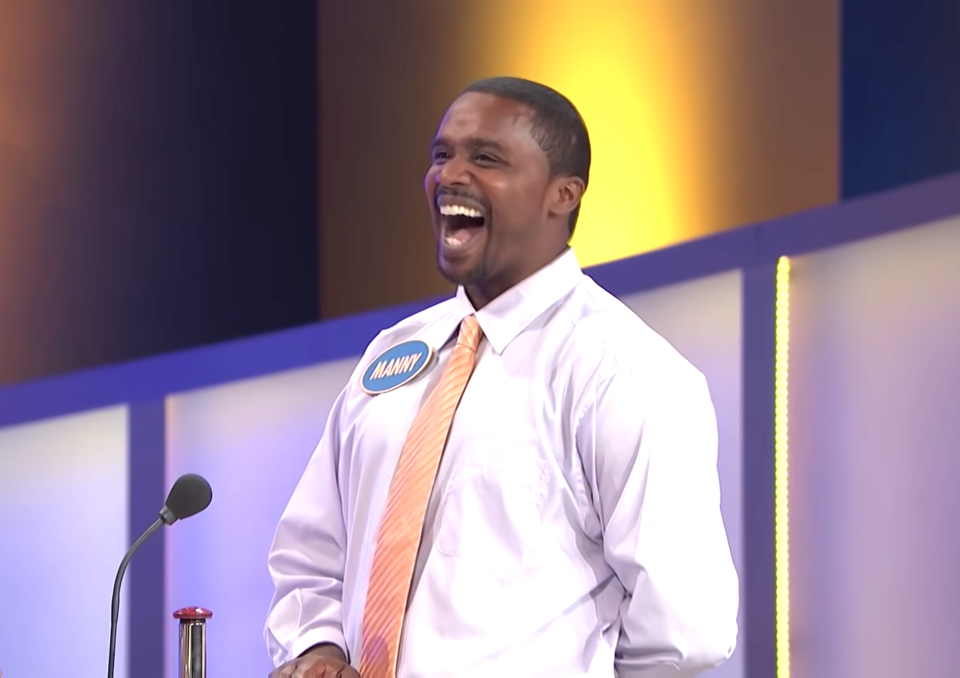 a man laughing on a game show