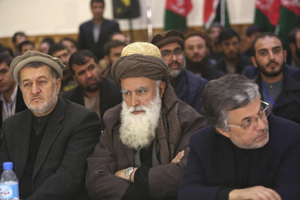 FILE - In this Dec. 18, 2015 file photo, former Afghan warlord Abdul Rasool Sayyaf, center, attends the inauguration of the Afghanistan Protection and Stability Council in Kabul, Afghanistan. Although the Taliban had promised Washington during months of negotiations that the U.S. will never again be attacked from Afghan soil, there's no evidence of a break in relations between long-time allies the Taliban and al-Qaida. Over the years, al-Qaida has had many friends in Afghanistan, some of whom are in high places today, such as Sayyaf, a powerbroker in Kabul. (AP Photo/Rahmat Gul, File)