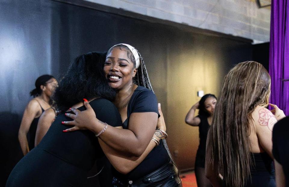 Amiah Nicks, right, owner of Millionaire Social, shares a hug with one of students as they nail down choreography that will be performed at the first dinner show at Millionaire Social in Charlotte, N.C., on Monday, January 29, 2024.