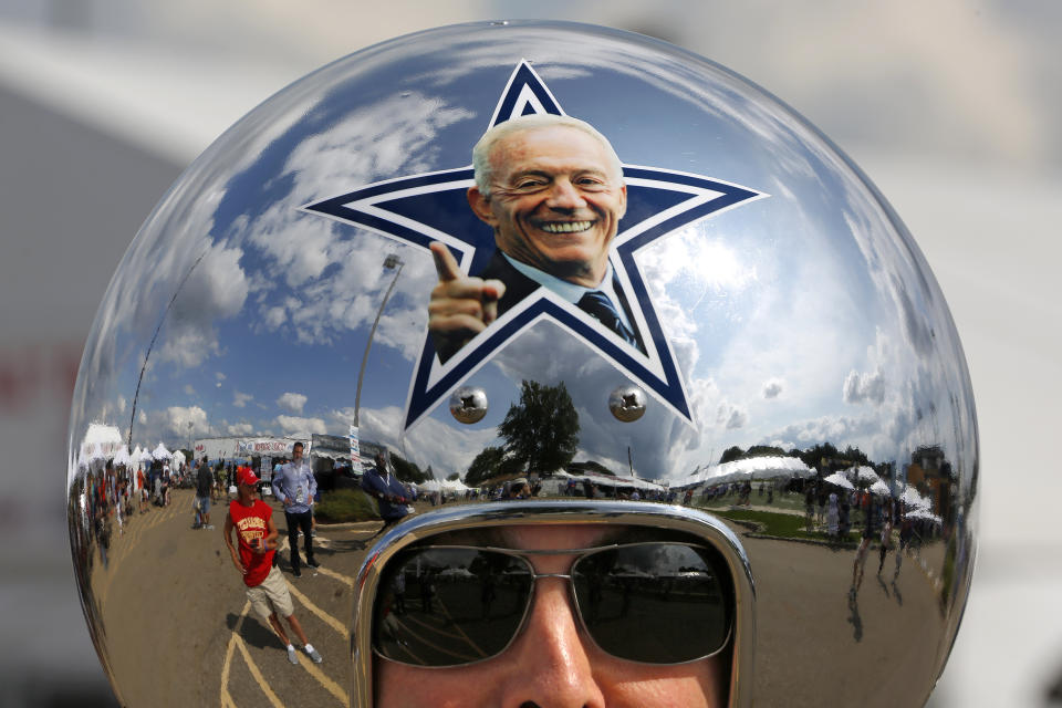 Dallas Cowboys fan Gregg Wilson, of Dallas, arrives for the Pro Football Hall of Fame inductions, including that of Cowboys owner Jerry Jones, whose photo is on the helmet, at the Pro Football Hall of Fame on Saturday, Aug. 5, 2017, in Canton, Ohio. (AP Photo/Gene J. Puskar)