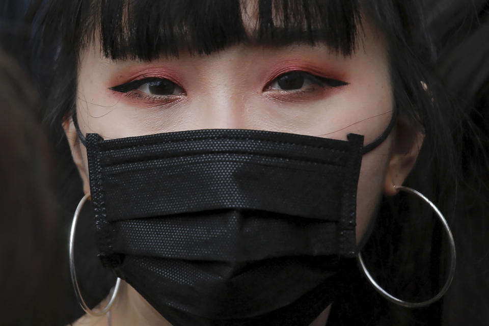A protester with a mask gathers with others near the Legislative Council as they continuing protest against the unpopular extradition bill in Hong Kong, Monday, June 17, 2019. A member of Hong Kong's Executive Council says the city's leader plans to apologize again over her handling of a highly unpopular extradition bill. (AP Photo/Kin Cheung)