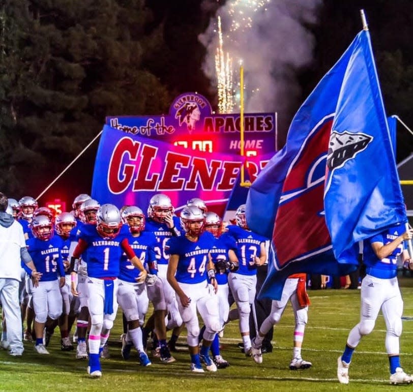 The Glenbrook football team enters the field prior to a game last season.