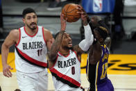 Los Angeles Lakers guard Dennis Schroder (17) blocks a shot by Portland Trail Blazers guard Damian Lillard (0) during the first half of an NBA basketball game Friday, Feb. 26, 2021, in Los Angeles. (AP Photo/Mark J. Terrill)