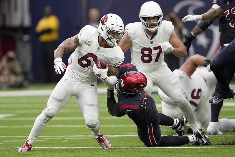 Arizona Cardinals running back James Conner (6) is stopped for a loss of yards by Houston Texans defensive end Will Anderson Jr., right, in the second half of an NFL football game in Houston, Sunday, Nov. 19, 2023. (AP Photo/David J. Phillip)