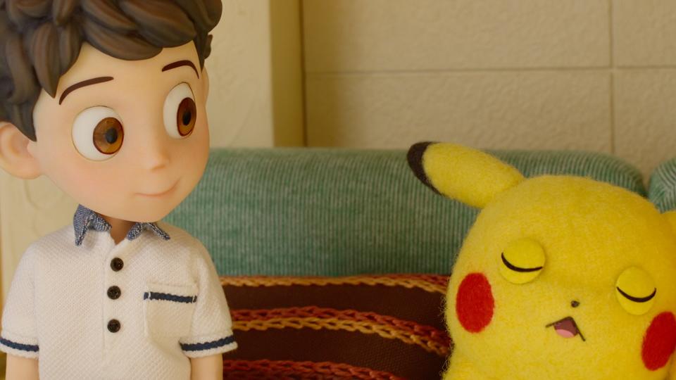 A still from Pokémon Concierge featuring a stop-motion young boy  and a Pikachu