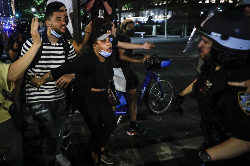 Protesters breaking curfew react as New York Police Department officers move in to make arrests on Fifth Avenue, Thursday, June 4, 2020, in New York. Protests continued following the death of George Floyd, who died after being restrained by Minneapolis police officers on May 25. (AP Photo/John Minchillo)