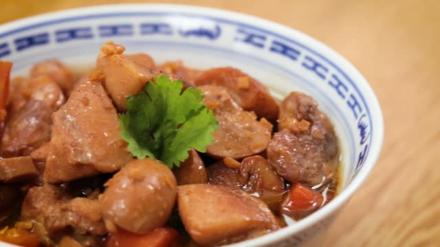 Braised chicken and button mushrooms in a blue Chinese porcelain bowl