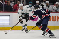 Washington Capitals defenseman Michal Kempny (6) defends San Jose Sharks defenseman Nicolas Meloche (53) during the second period of an NHL hockey game, Wednesday, Jan. 26, 2022, in Washington. (AP Photo/Evan Vucci)