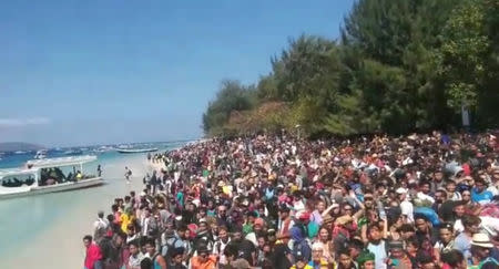 People crowd on the shore as they attempt to leave the Gili Islands after an earthquake Gili Trawangan, in Lombok, Indonesia, August 6, 2018, in this still image taken from a video. Indonesia Water Police/Handout/via REUTERS