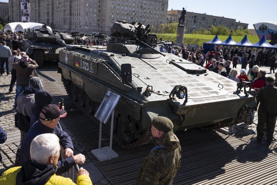 Visitors look at a Marder armored infantry vehicle from Germany at an exhibition of Western military equipment captured from Kyiv forces during the fighting in Ukraine, in Moscow on Friday, May 3, 2024. The exhibit organized by the Russian Defense Ministry features more than 30 pieces of Western-made heavy equipment, including a U.S.-made M1 Abrams tank and a Bradley armored fighting vehicle. (AP Photo/Alexander Zemlianichenko)