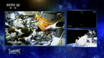 In this image taken from video footage run by China's CCTV, Chinese astronauts are seen aboard a Shenzhou-12 spaceship in space, Thursday, June 17, 2021. The Shenzhou-12 spaceship has docked with China's new space station at the start of 3-month mission, marking a milestone in the country's ambitious space program. (CCTV via AP Video)