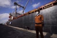 A port worker stands by a ship that carried emergency supplies granted as humanitarian aid by India's Tamil Nadu government to Sri Lankan people at a port in Colombo, Sri Lanka, Sunday, May 22, 2022. The consignment, which consists of 9,000 MT of rice, 50 MT of milk powder and more than 25 MT of drugs and other medical supplies. (AP Photo/Eranga Jayawardena)