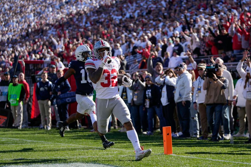 Oct 29, 2022; University Park, Pennsylvania, USA; Ohio State Buckeyes running back TreVeyon Henderson (32) runs past Penn State Nittany Lions safety Ji'Ayir Brown (16) for a 41-yard touchdown during the fourth quarter of the NCAA Division I football game at Beaver Stadium. Mandatory Credit: Adam Cairns-The Columbus Dispatch