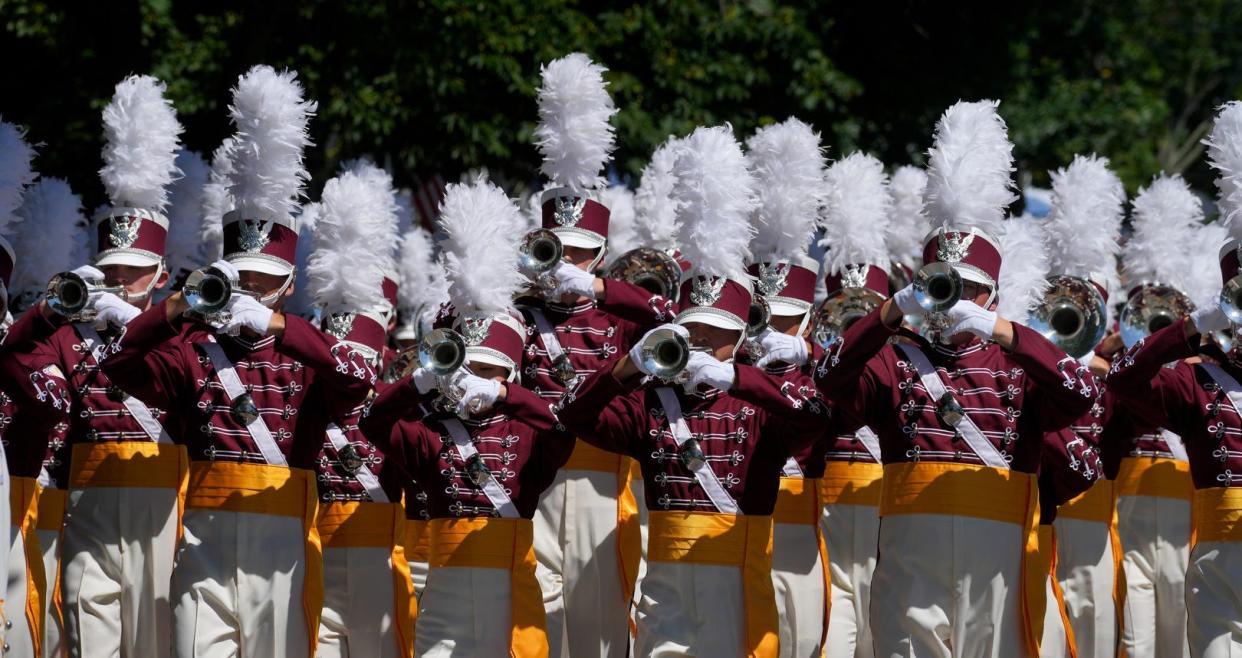 The Cadets Marching band Drum and Bugle Corp perform along Hope St. at the 237th Bristol 4th of July parade.