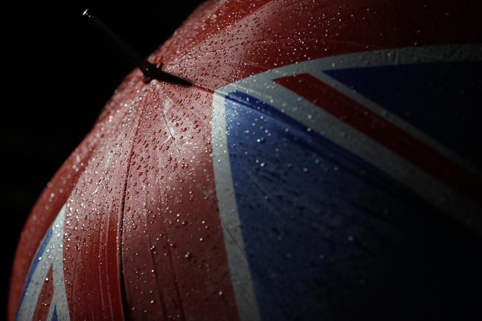 Rain drops are seen on the umbrella of a Brexit supporter during a rally in London, Friday, Jan. 31, 2020. Britain officially leaves the European Union on Friday after a debilitating political period that has bitterly divided the nation since the 2016 Brexit referendum. (AP Photo/Frank Augstein)