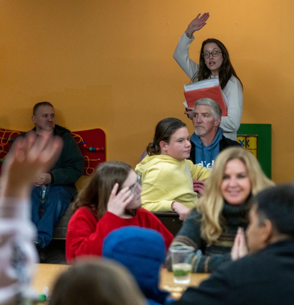 Katy Williams, support group coordinator, makes announcements on Monday, Dec. 12, 2022, at a meeting for Brooke’s Place, which helps grieving young people. 