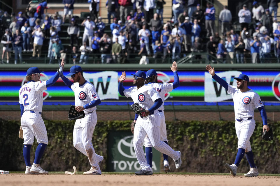 The Chicago Cubs celebrate the team's 8-3 win over the Miami Marlins in a baseball game Friday, April 19, 2024, in Chicago. (AP Photo/Charles Rex Arbogast)