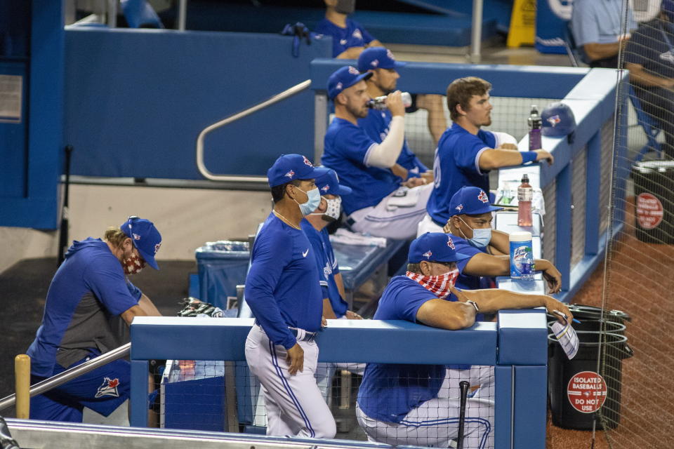 The Toronto Blue Jays occupy the dugout during intrasquad baseball game action in Toronto, Friday, July 10, 2020. (Carlos Osorio/The Canadian Press via AP)