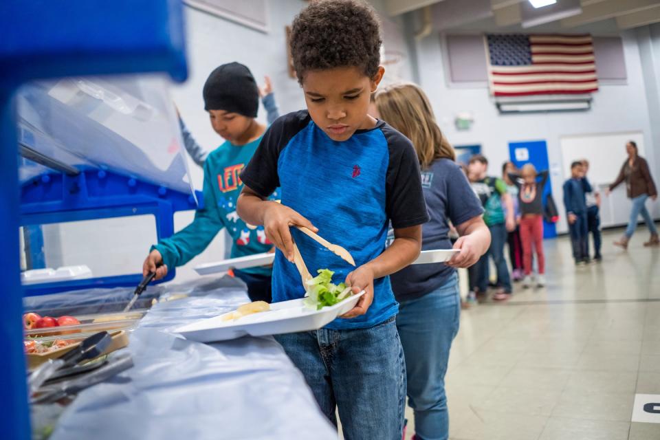 Students select vegetables from a salad bar during lunch at a Michigan elementary school in early November.