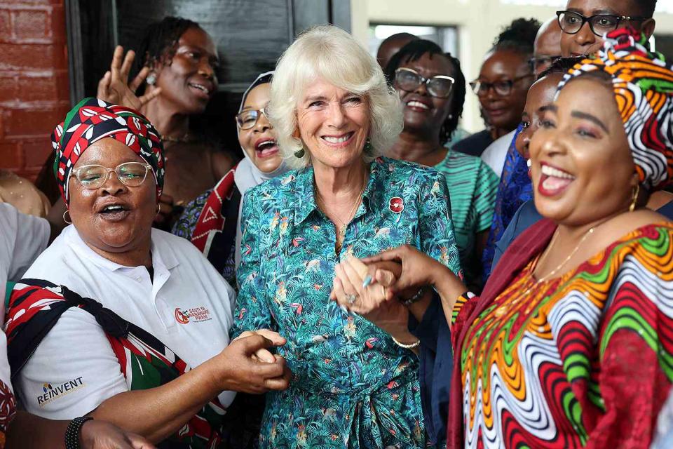 <p>Chris Jackson/Getty </p> Queen Camilla dances with volunteers and staff from Sauti Ya Wanawake at the Situation Room on November 3 in Mombasa, Kenya.