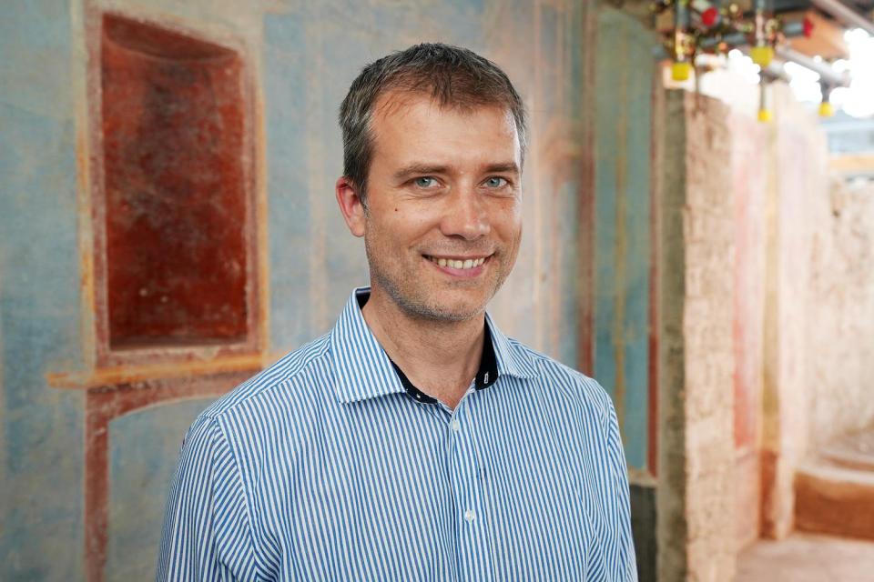 Gabriel Zuchtriegel smiles as he poses for a portrait in the blue room (Angela Neil/NBC News)