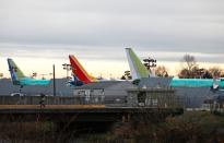 A worker walks across an access bridge from the Renton Municipal Airport storage area to Boeing's 737 Max production facility