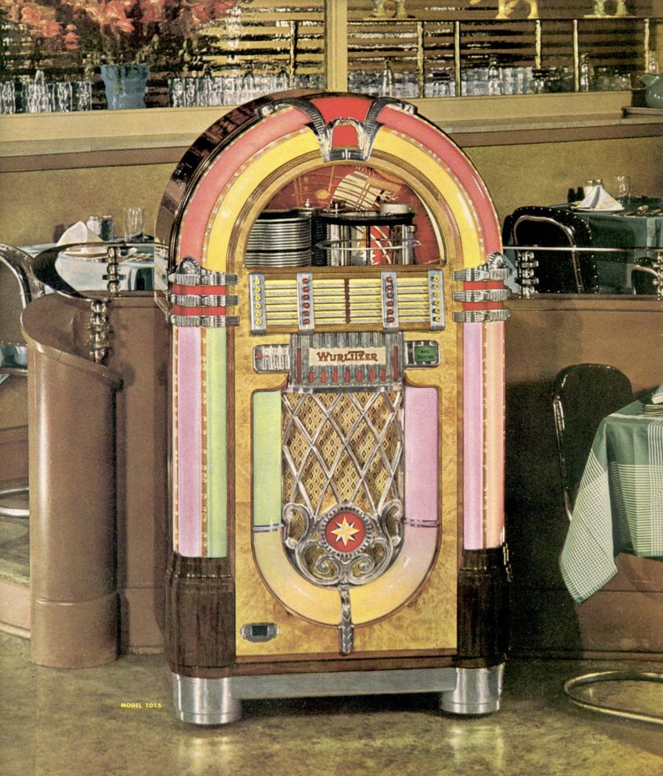 A catalog advertisement for a Wurlitzer 1015 jukebox from 1946 shows the iconic design.