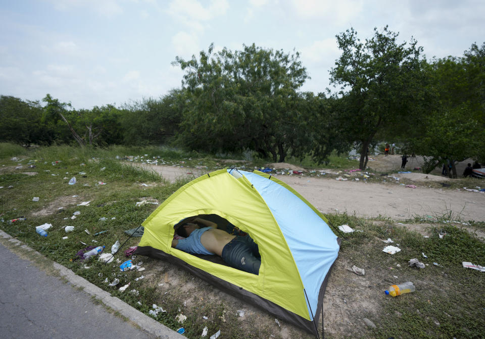 A migrant sleeps in a tent on a bank of the Rio Grande in Matamoros, Mexico, Friday, May 12, 2023, the day after pandemic-related asylum restrictions called Title 42 were lifted. (AP Photo/Fernando Llano)