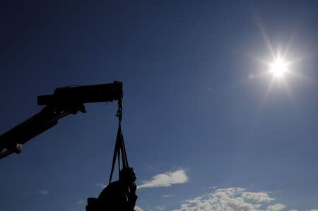 A crane stands ready to remove the statue of Cecil John Rhodes from the University of Cape Town (UCT), April 9, 2015. REUTERS/Mike Hutchings