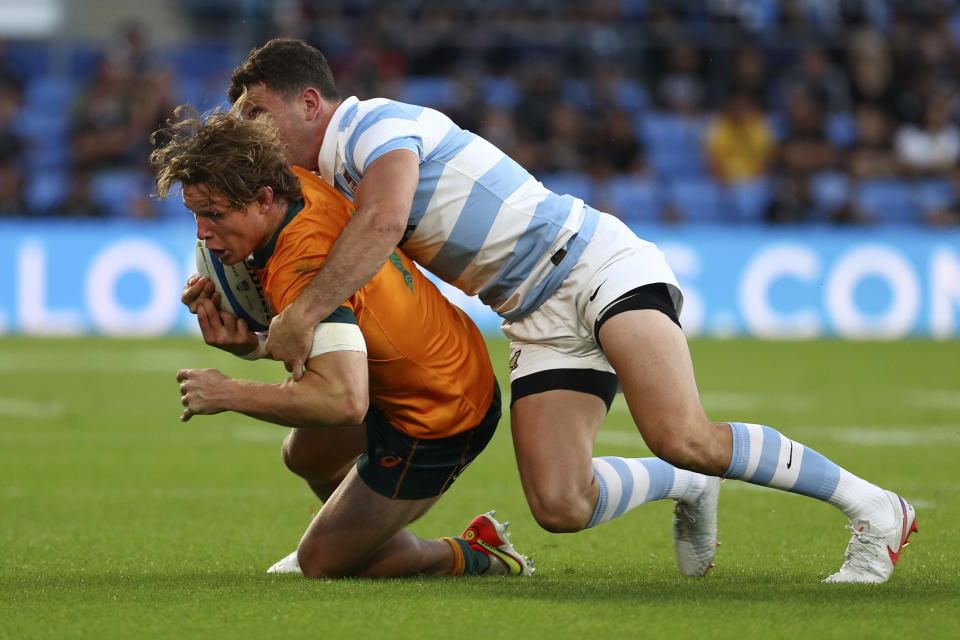 Australia's Michael Hooper, left, is tackled by Argentina's Emiliano Boffelli during their Rugby Championship test match on the Gold Coast, Australia, Saturday, Oct. 2, 2021. (AP Photo/Tertius Pickard)