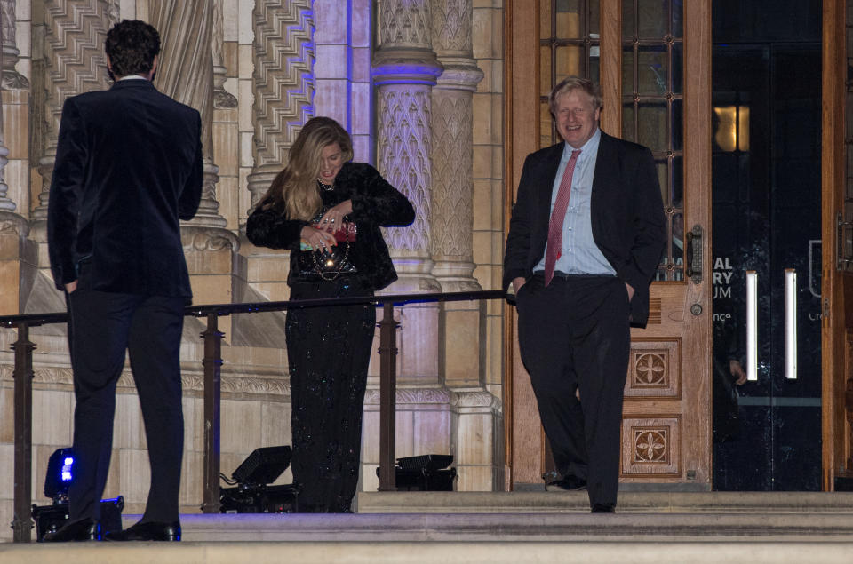 LONDON, ENGLAND - FEBRUARY 07:  Foreign Secretary Boris Johnson passes Carrie Symonds as he leaves the Conservative party Black and White Ball at Natural History Museum on February 7, 2018 in London, England. The ball is a fundraising event for the political party where donors pay to spend the evening with cabinet ministers and the Prime Minister.  (Photo by Chris J Ratcliffe/Getty Images)